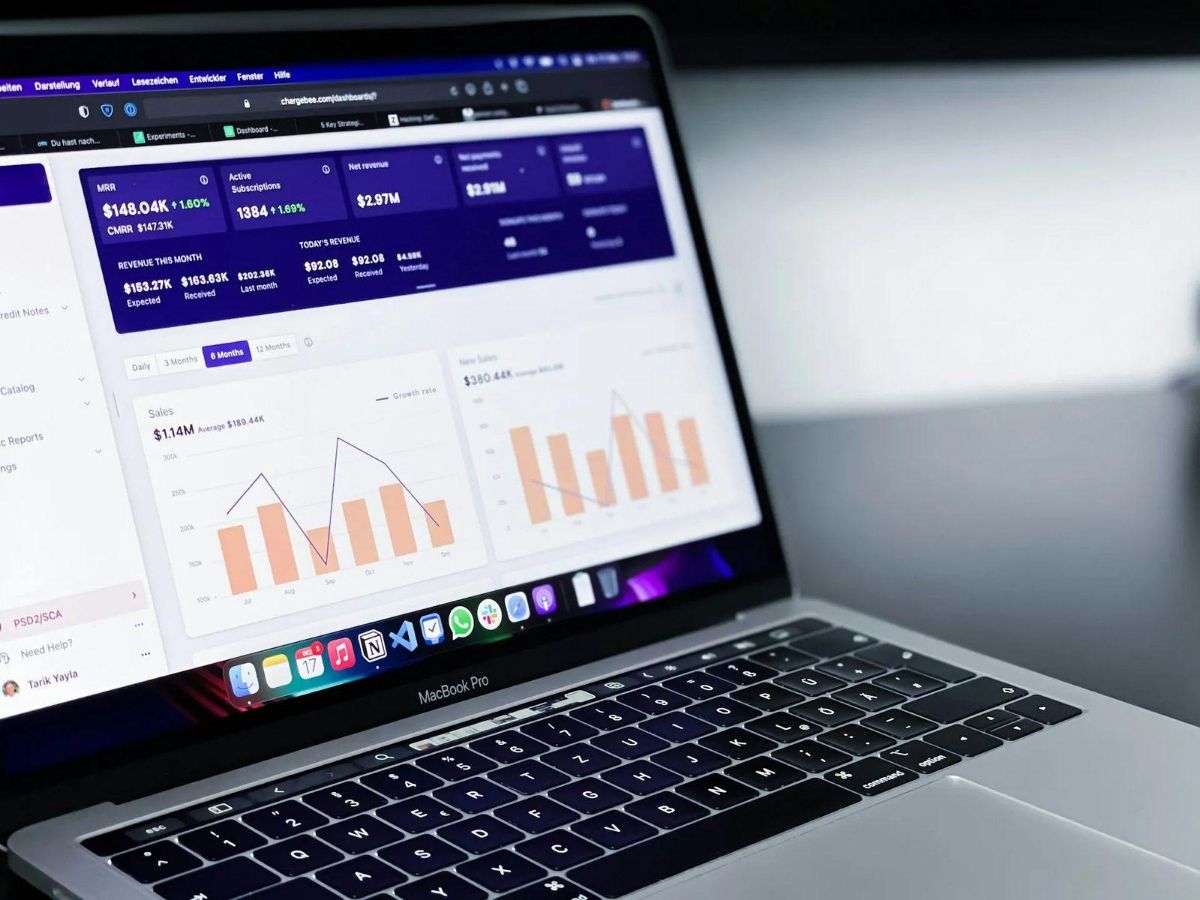 Laptop showing a business revenue dashboard with charts