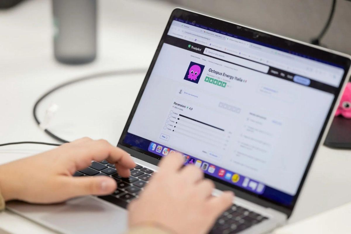 Person using a laptop that shows a page of online company reviews