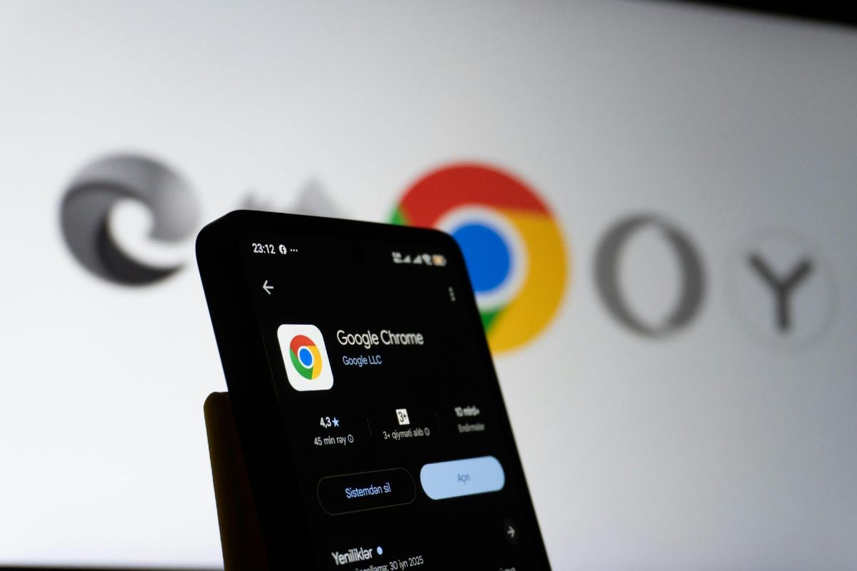 Phone showing a Google Chrome app store page in front of browser logos