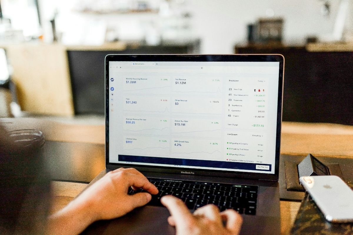 Laptop showing a revenue dashboard with charts and totals